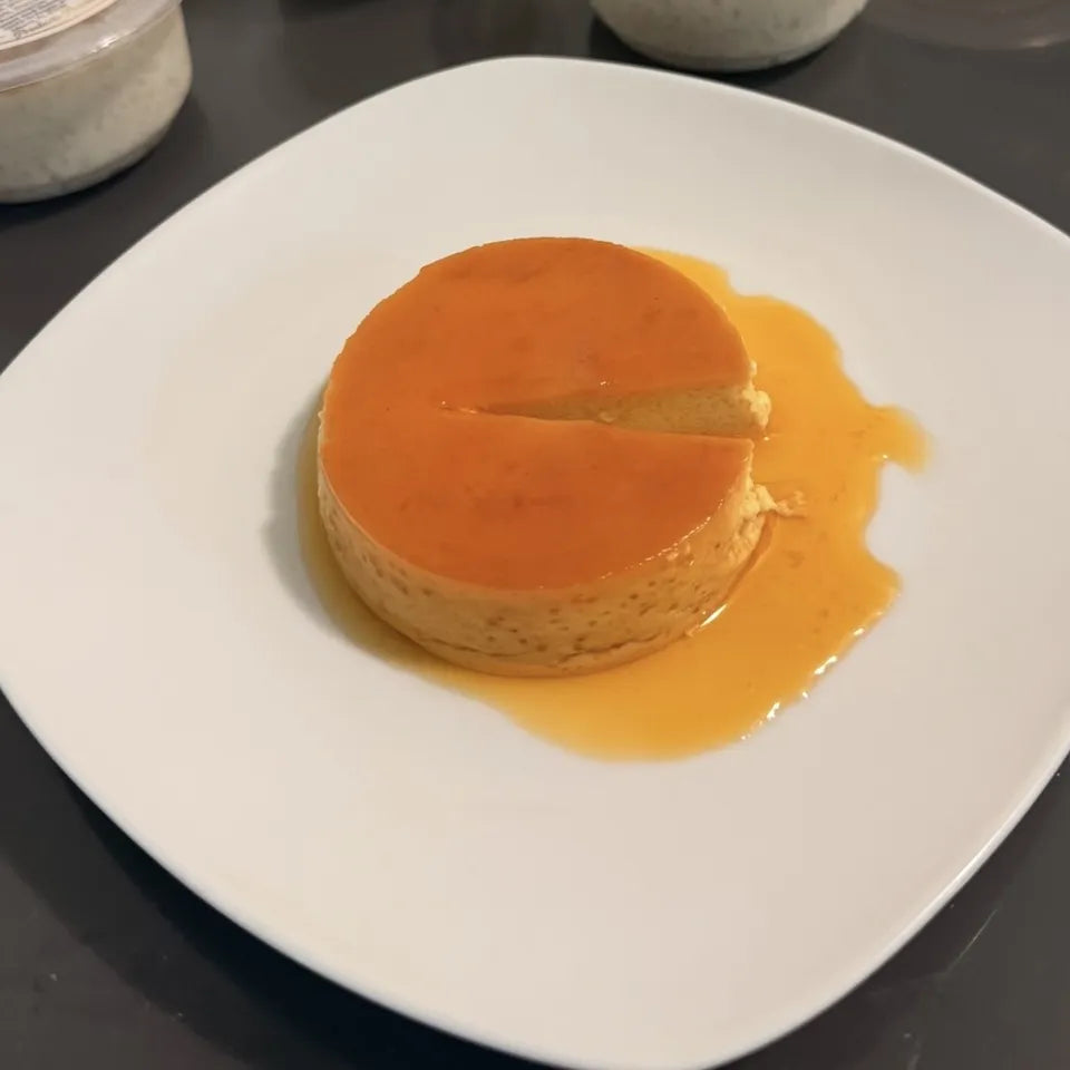 Flan cubano con su caramelo, servido en plato para la merienda de la oficina en Miami